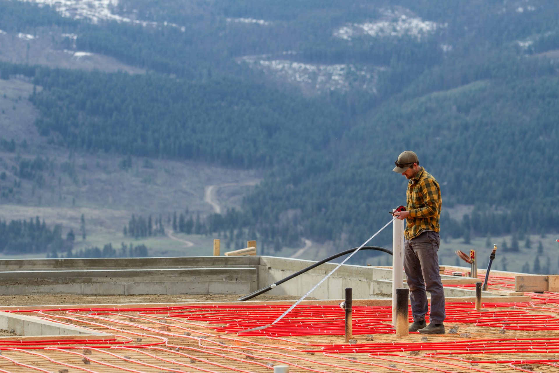 Construction company measuring a build