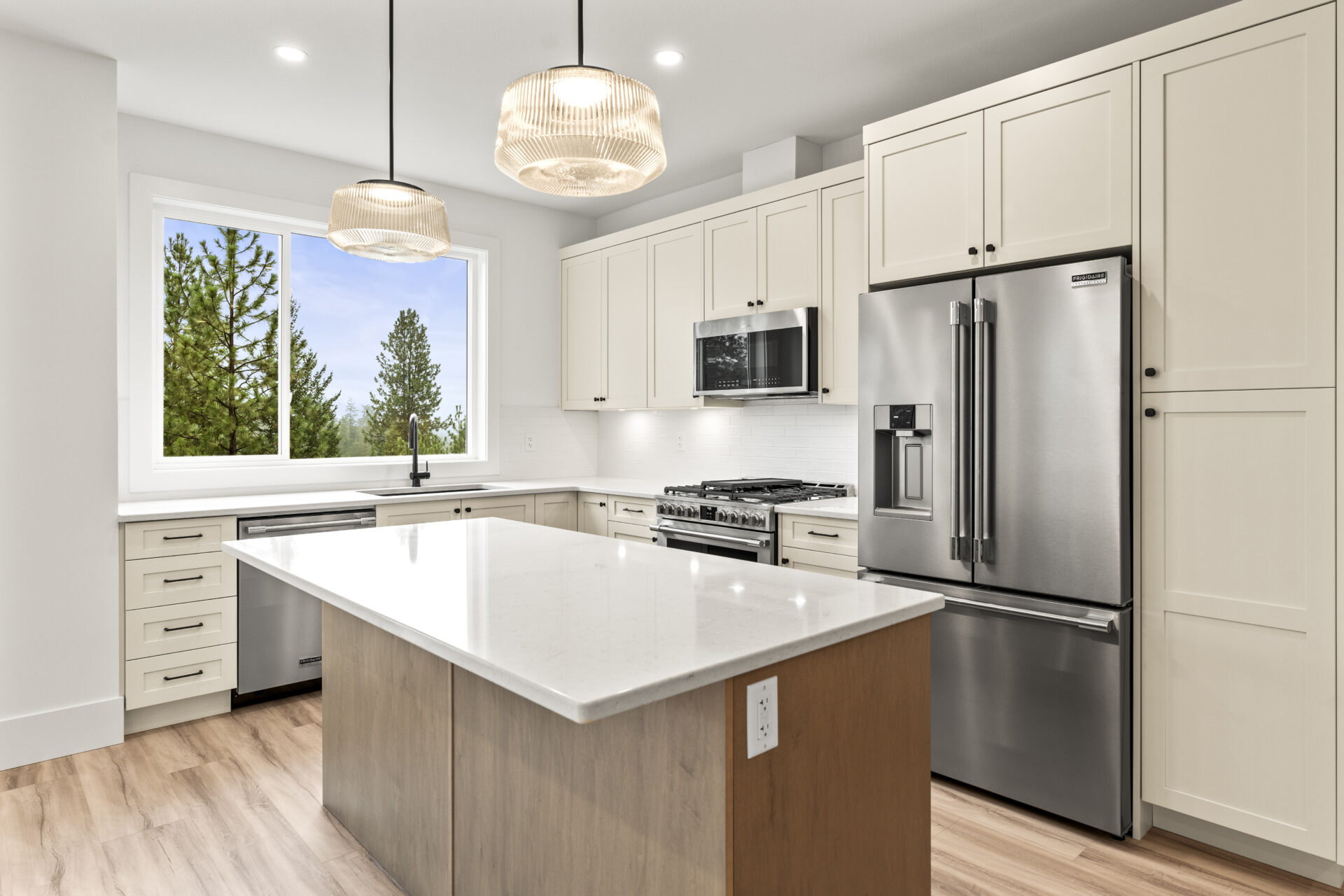 contemporary kitchen with cream cabinets and white counters